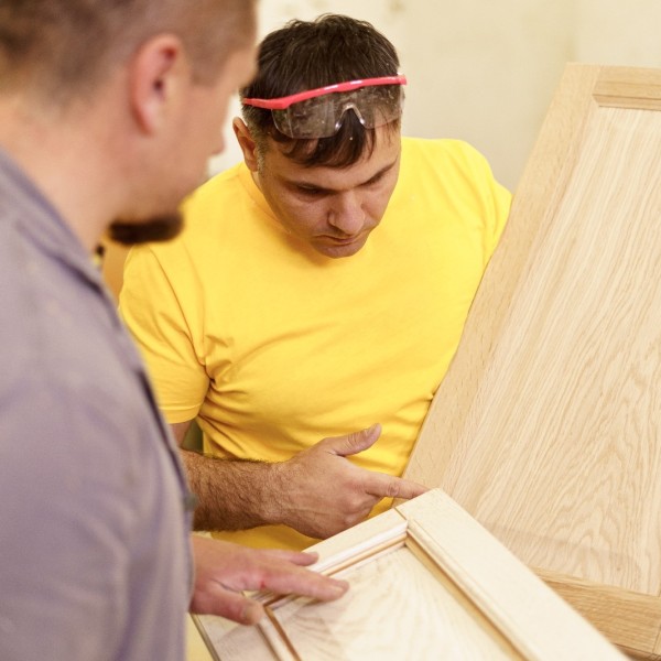 profession-carpentry-woodwork-people-concept-two-carpenterswork-with-wood-furniture-workshop